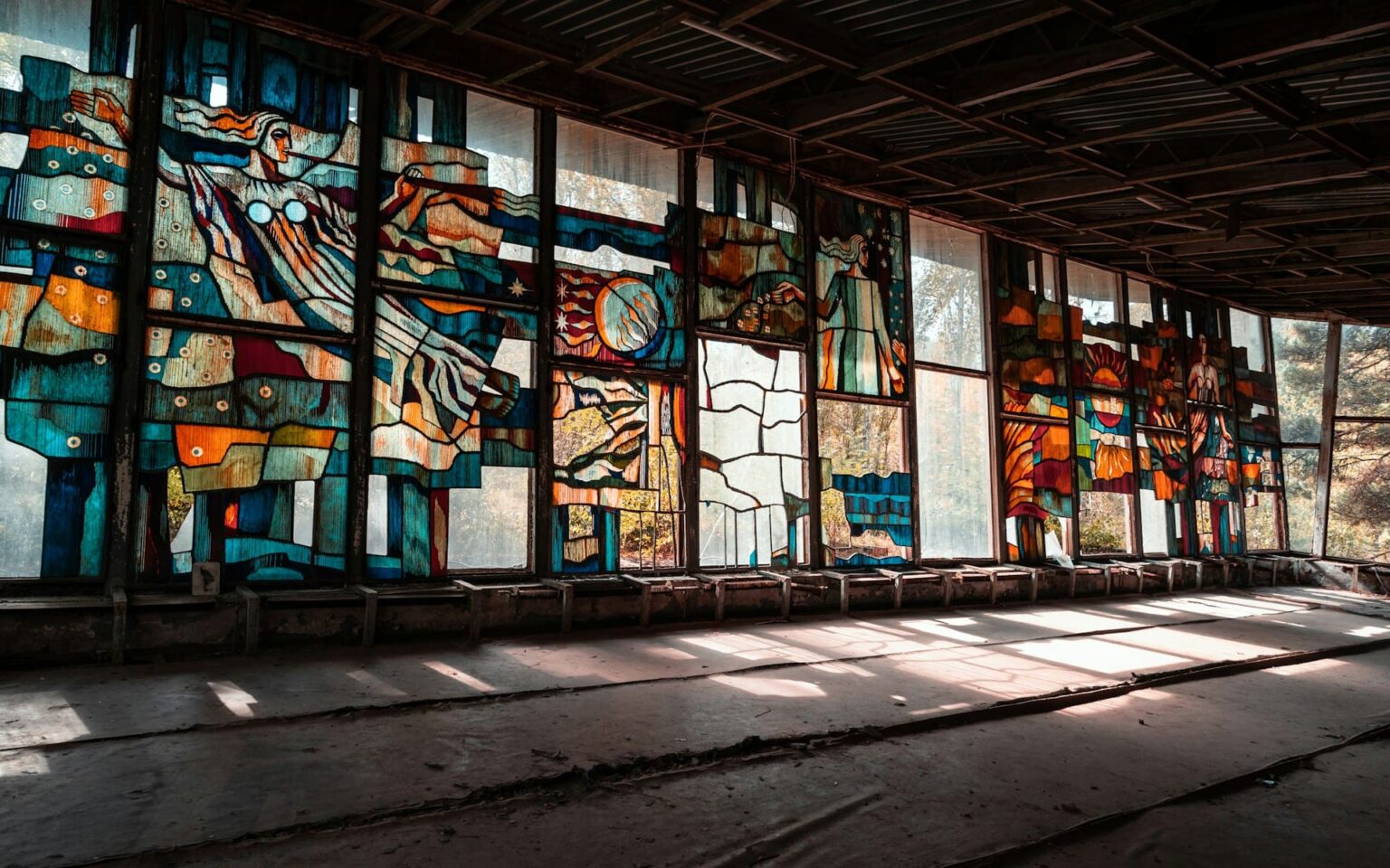 Advérbios (прислівники) em ucraniano Vitrais coloridos com figuras em um salão abandonado, iluminado pela luz das janelas